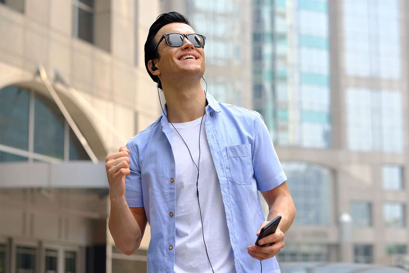 young man on a walking audio tour outside in a city