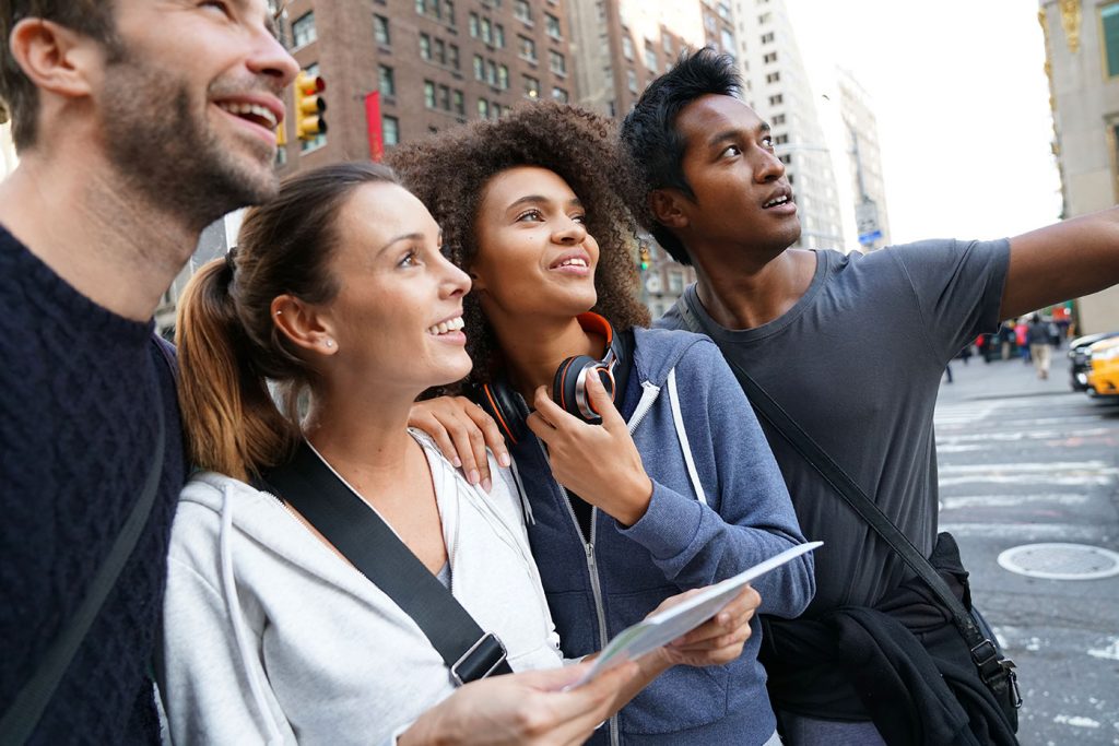 group of tourists looking up in a city on a walking tour